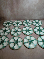 Service 12 assiettes + plat à huîtres Longchamp barbotine coquille